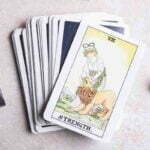 Strength Tarot Card Meaning: Love, Money, Health & More